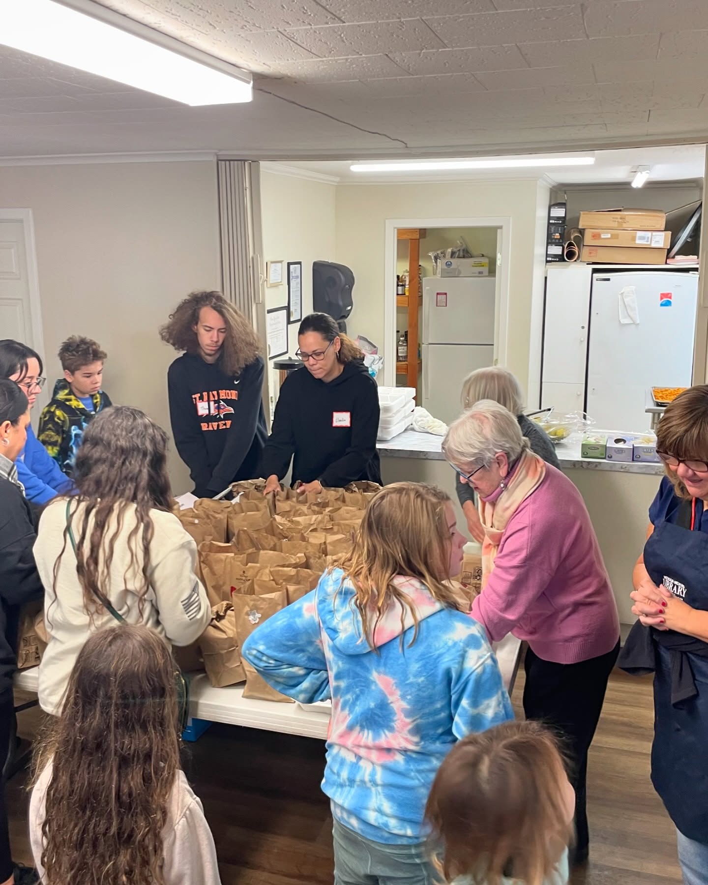 Volunteers pack bags of food