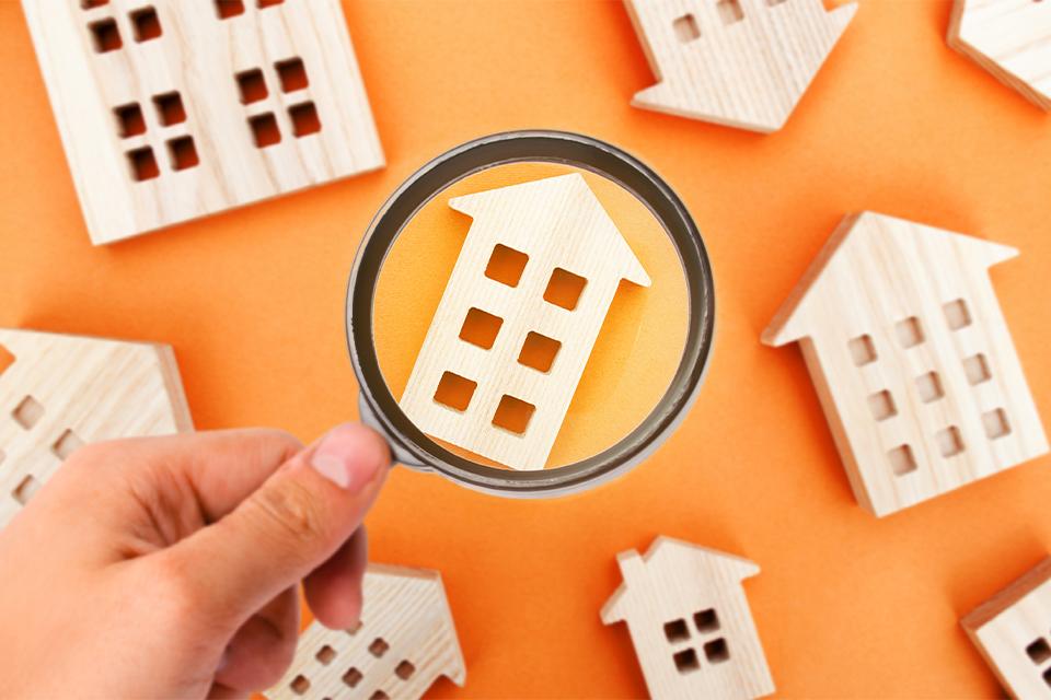 Magnifying glass and wooden houses