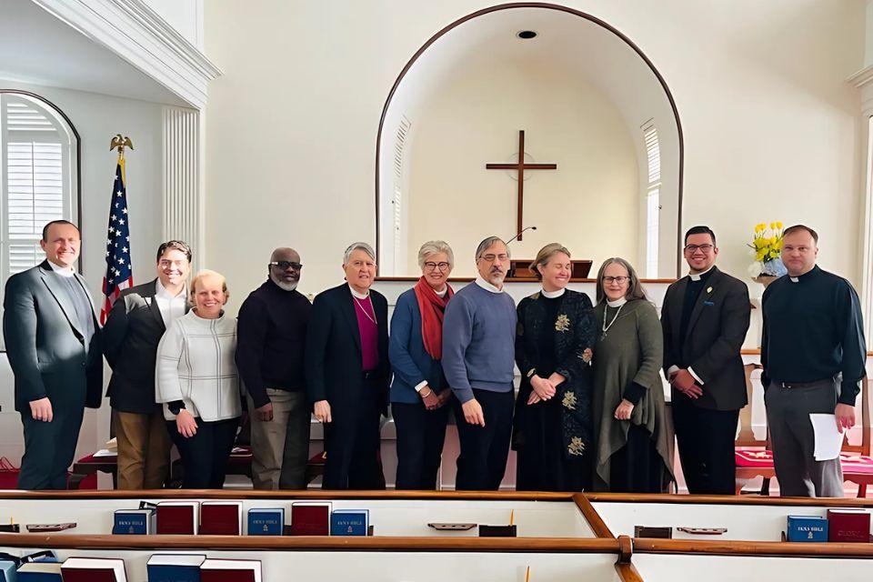 Members of Episcopalians and Presbyterians in Conversation (EPIC) pose inside a church