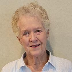 Headshot of Jane Ames, head tilted to the left, a s mile on her face.