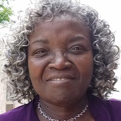 Headshot of Vernese Smith, smiling, wearing a silver necklace