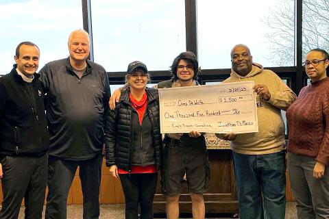 Eagle Scout and troop present check to Camp DeWolfe