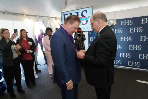 Retiring celebrate St. John's Episcopal Hospital's CEO Gerard Walsh receives the Bishop's Cross from the Rt. Rev. Lawrence Provenzano, who heads Episcopal Health Services. MELISSA BERMAN/HERALD