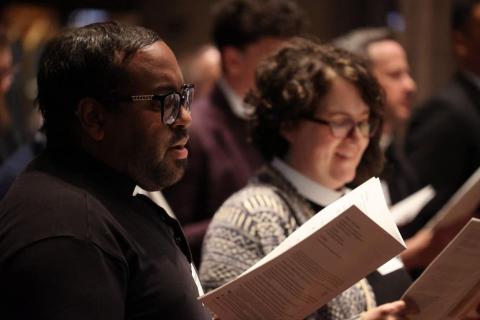 Young clergy gather singing a hymn