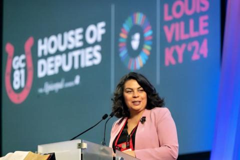 Julia Ayala Harris speaks at a podium microphone