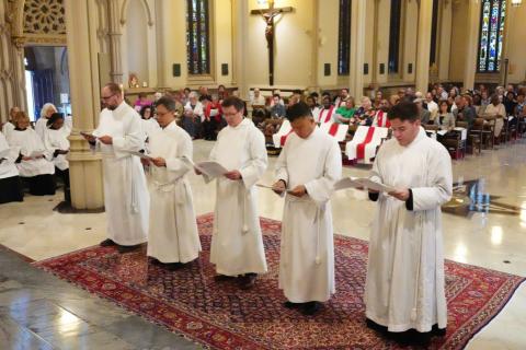 Five ordinands stand in a line in the Cathedral of the Incarnation