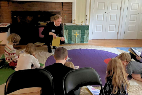Fr. Durango Jenkins teaches sunday school on the floor